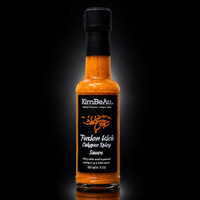 Premium KimBeAu Fusion Kick Calypso Spicy Sauce bottle displayed against a dark background.
