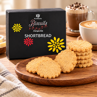 Luxury KimBeAu Shortbread Biscuits displayed on a wooden board with elegant black packaging.
