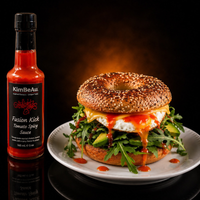 KimBeAu Tomato Spicy Sauce served with a gourmet bagel topped with cheese, avocado and a fried egg.