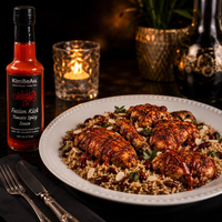 Elegant dinner table presentation featuring KimBeAu Tomato Spicy Sauce with rice, chicken and herbs.